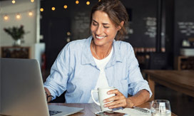 woman sitting in a cafe with her laptop
